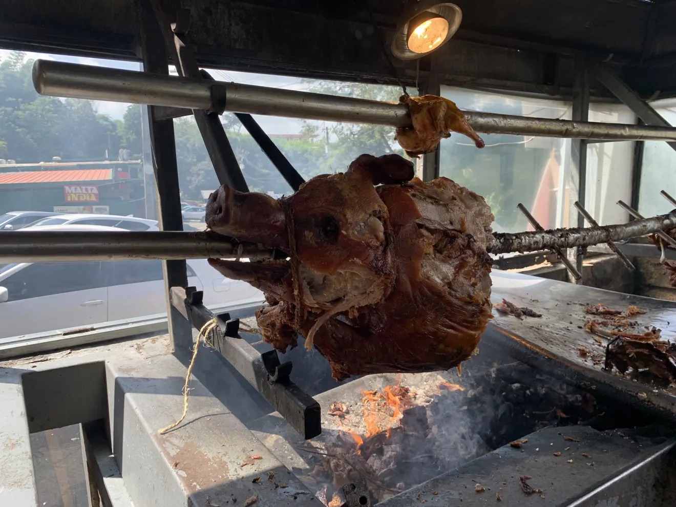Puerto Rican pork roasting on a spit