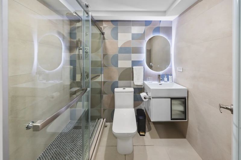 Maréa bathroom with glass shower and illuminated mirror