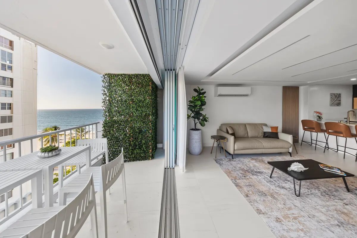 Terra Noir living room with dark modern furnishings and ocean light